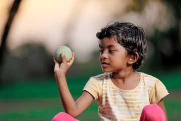 indian girl child playing with ball