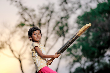 indian girl child playing cricket