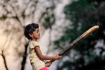 indian girl child playing cricket