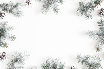 Christmas composition. Frame made of fir tree branches, pine cones on white background. Christmas,...