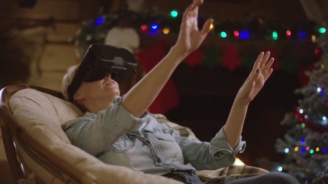 Woman got a virtual reality glasses for Christmas and using them