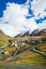 Picturesque landscape of aged Georgian rural community Ushguli in valley of beautiful mountains with snowy peaks