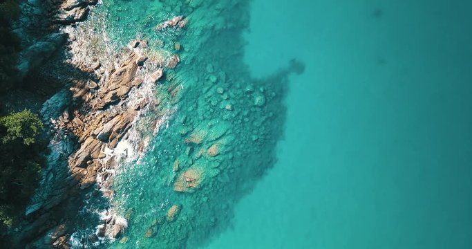 Aerial drone top view of the amazing rocky and green coast on the tropical island