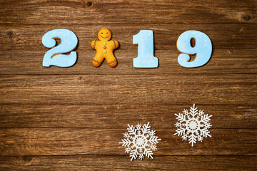 Gingerbread cookies over wooden background. Flat lay festive composition with copy space.