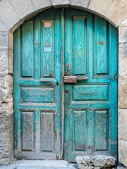 Old turquoise door in stone building in Tarsus, Turkey