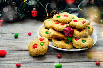 Shortbread cookies with multi colored candy and chocolate chips, served with glass of milk, square format
