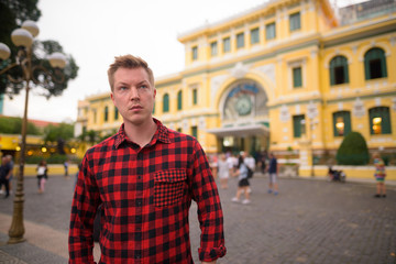 Tourist man in front of Saigon Central Post Office