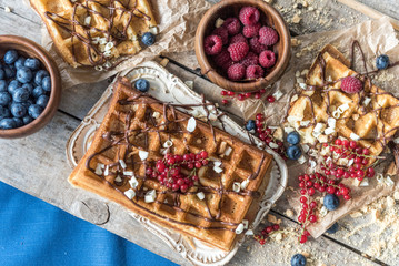 Top view of waffles with berries and chocolate