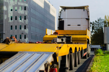 big yellow truck standing by the road