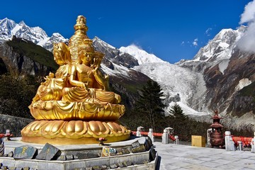 Golden statue and Mt. Gongga in the background, Sichuan, China 