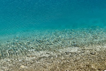 Unique crystal clear water of the Milk lake (approx. 4300m altitude) in Daocheng Yading Nature Reserve, Sichuan, China.  