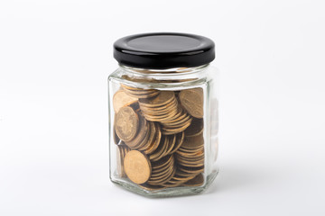 Coins In Glass Bottle On White
