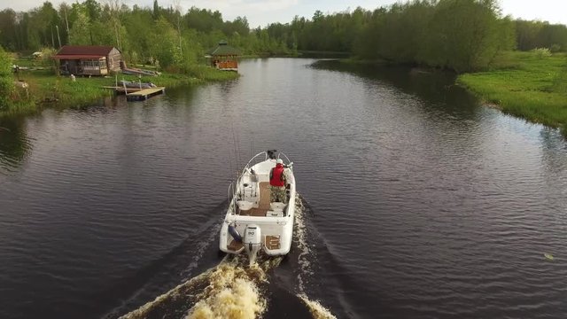 Camera follows the boat sailing on the river Aerial image