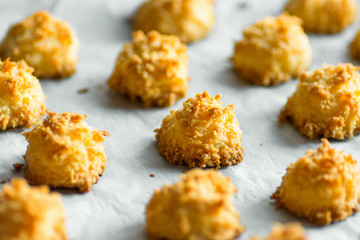 Christmas coconut puffs macaroon cookies on parchment paper on tray. Festive cozy home atmosphere....