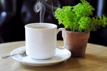 Hot coffee on the wooden table
