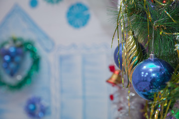 A Christmas blue balls hangs on the background . It's time for a new year. Multicolored glare and...