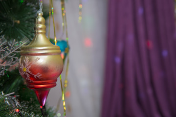 A Christmas gold and red ball hangs on the background of a clock. It's time for a new year....