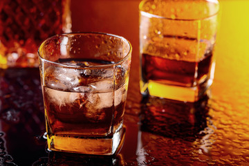 Glass of scotch whiskey with natural ice .