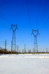 Electric power tower in the snow