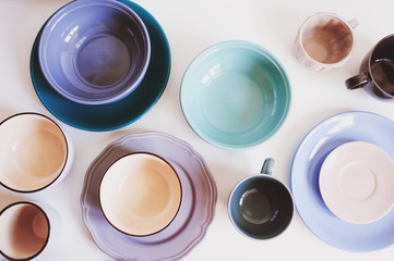 natural crockery tableware on wooden background. Ceramic dished and cups in neutral tones, scandinavian style.