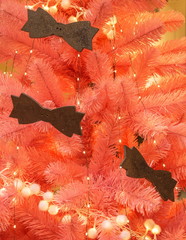 Pink Christmas tree decorated with elegant bow ties
