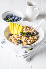 Oatmeal with mango and blueberry.