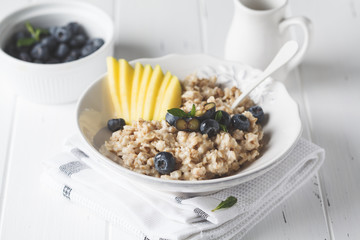 Oatmeal with mango and blueberry.