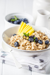 Oatmeal with mango and blueberry.