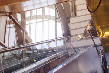 Empty escalator on the background of a large window in a modern station building