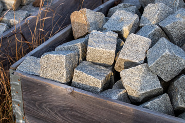 Pile of square stones in a wooden box