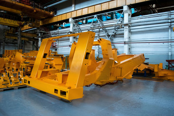 Line, conveyor for the production of large yellow trucks, mining trucks.