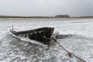  The wreck of a frozen fishing boat in the lake