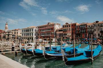 Fototapeta premium gondolas in venice under summer blue sky