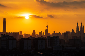 Majestic sunset over downtown Kuala Lumpur in silhouette.  