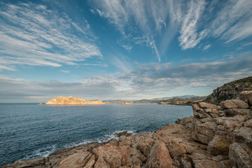 Evening sun on red rock of Ile Rousse in Corsica