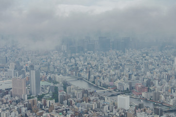 Aerial view of Tokyo cityscape from high above. Dense populated area with many buildings.