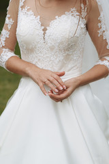 bride looks at her beautiful gold wedding ring