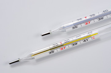 Glass medical thermometer thermometer for measuring body temperature shot on a white background