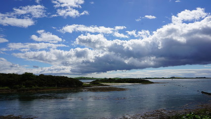 sea with blue sky and clouds