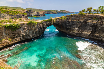 Fototapeta na wymiar Beautiful landscape of a Broken Beach, located in Nusa Penida Island, the southeast island of Bali, Indonesia. The amazing tourist attraction of the rock, cliff, mountain, and ocean waves.