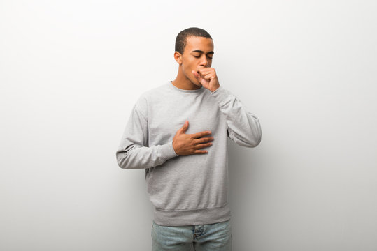 African american man on white wall background is suffering with cough and feeling bad