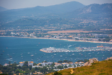 Port de Pollensa, Mallorca, Spain - July 19, 2013: View from Cape Formentor on the city, yachts, beach, streets, hotels.