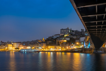 Fototapeta na wymiar view of porto under the bridge dom luis at night