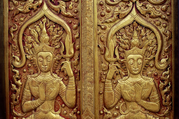 Fototapeta na wymiar pattern on temple wall in Chiangrai temple north of Thailand with soft-focus and over light in the background