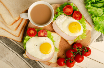 Fototapeta na wymiar Ham sandwich with scrambled egg, tomato, lettuce, delicious healthy breakfast