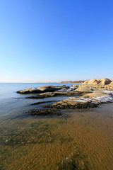 Sea reefs under the blue sky