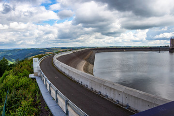 Upper reservoir of the Pumped-Storage Hydroelectric Power Station of Vianden, Luxembourg above Saint Nicholas Mountain under dramatic overcast summer sky, partial view