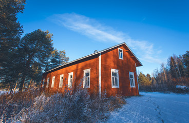Old red house in winter landscape. Sotkamo,Finland.