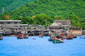 Fishing village on coast The green hills and crystal clear water