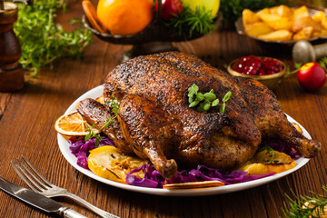 Baked whole duck, served with apples, red cabbage, oranges and roasted fritters.